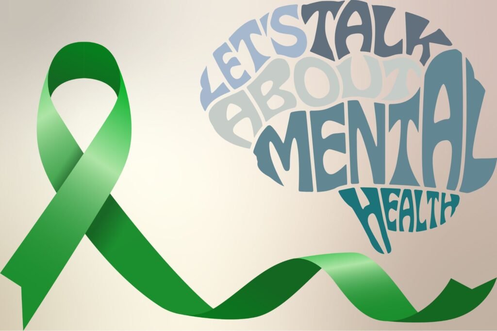 Green mental heath ribbon, human brain in written text stating 'let's talk about mental health'.