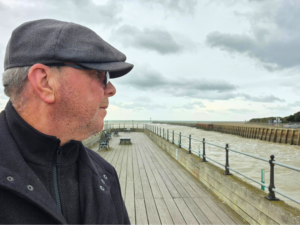 Nick Maison looking wistfully along a river mouth in quiet reflection